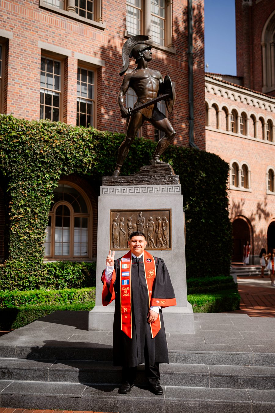 Nathan Castillo in USC regalia at the Tommy Trojan statue